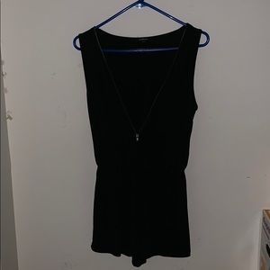 Black romper with a gold zipper